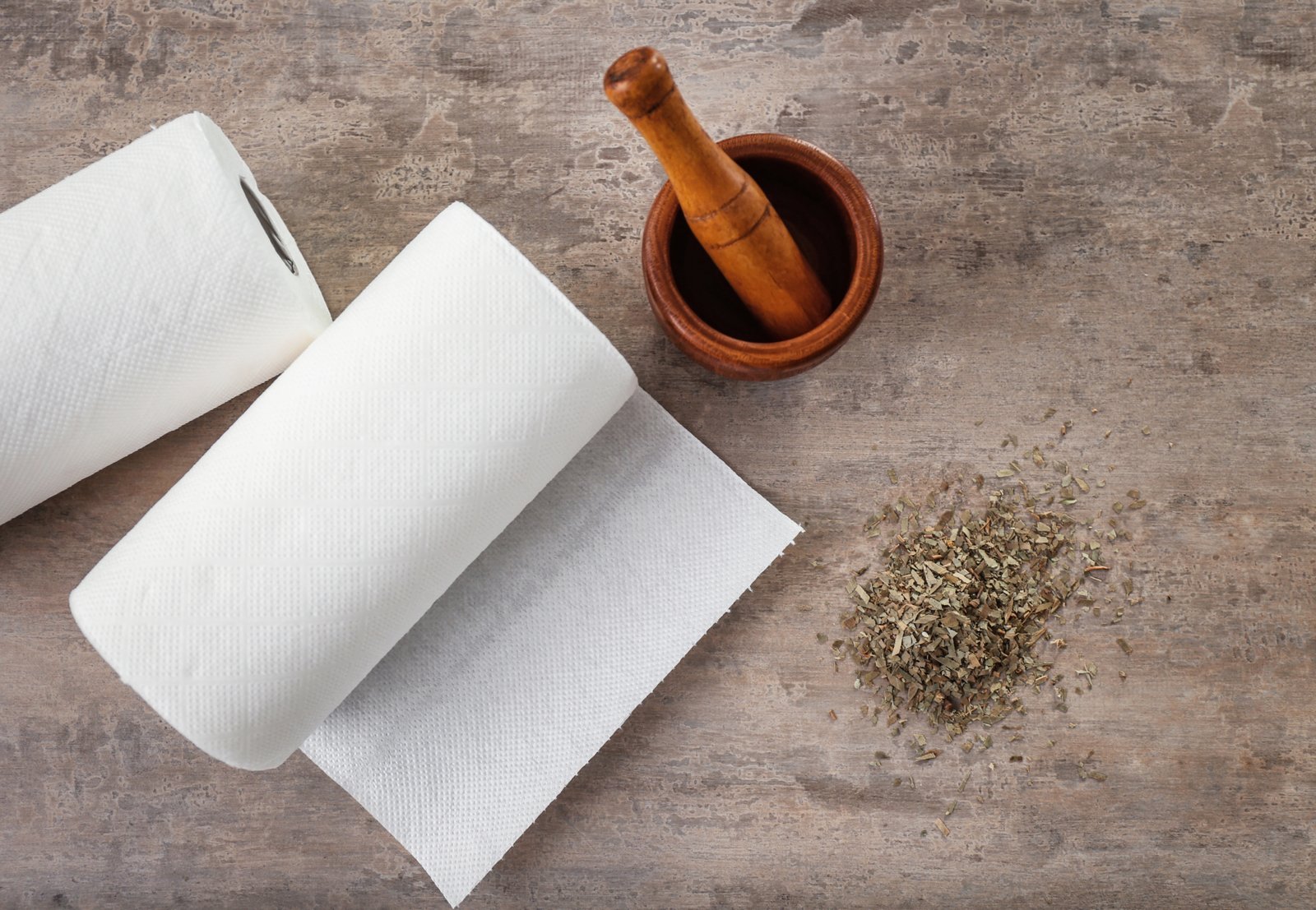 Rolls,Of,Paper,Towels,,Mortar,And,Pestle,On,Kitchen,Table