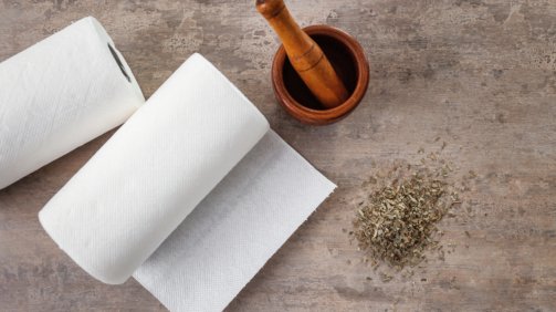 Rolls,Of,Paper,Towels,,Mortar,And,Pestle,On,Kitchen,Table