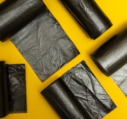 New,Black,Garbage,Bags,On,A,Yellow,Background.