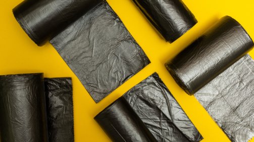 New,Black,Garbage,Bags,On,A,Yellow,Background.